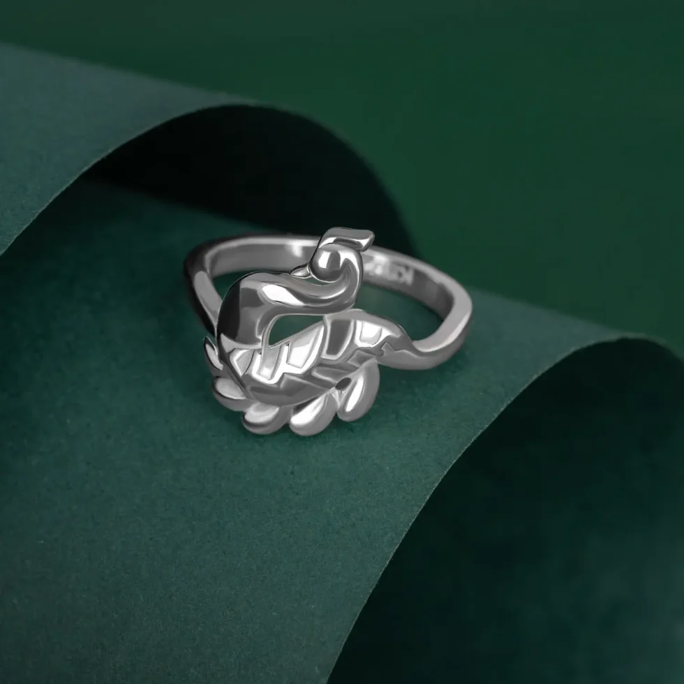 Peacock Glory Ring R 219 on table